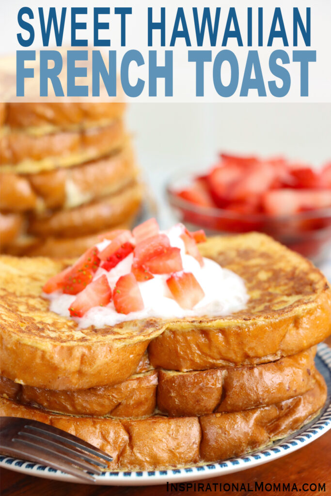 Closeup shot of stack of sweet Hawaiian bread French toast topped with whipped cream and strawberries on plate