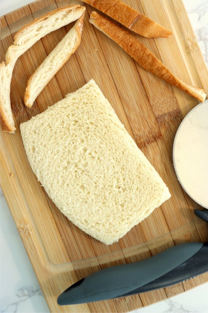 Overhead shot of bread with crust removed on cutting board