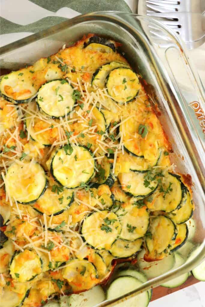 Closeup shot of baked zucchini carrot casserole in dish.