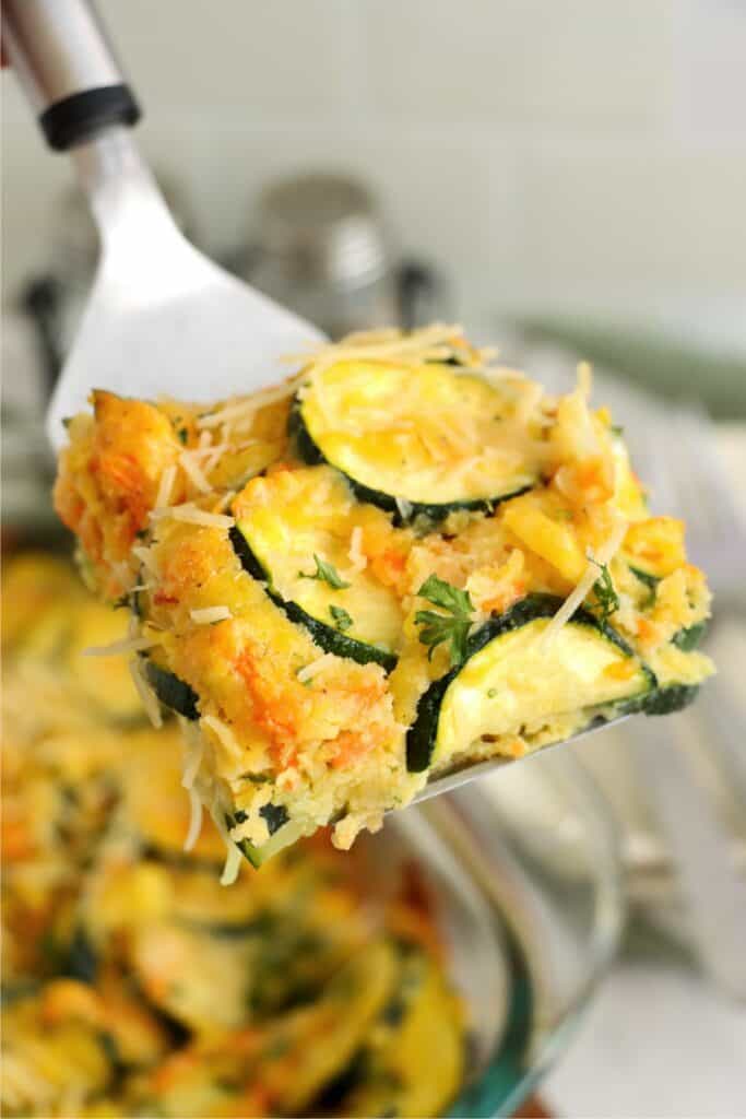 Closeup shot of slice of zucchini carrot casserole on spatula