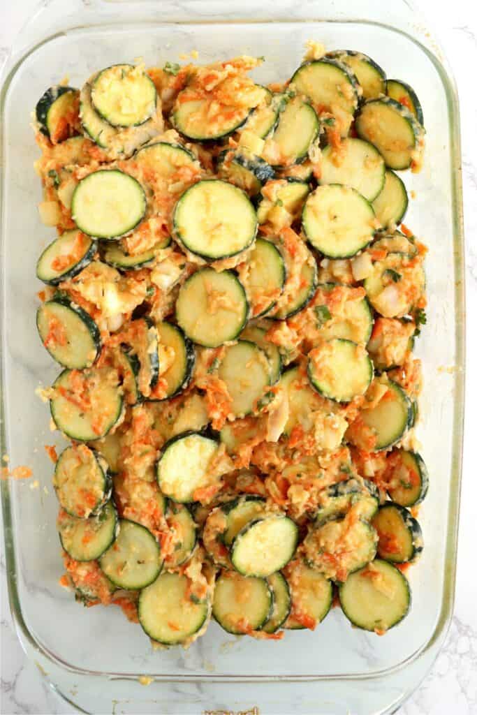 Closeup overhead shot of unbaked zucchini carrot casserole in dish