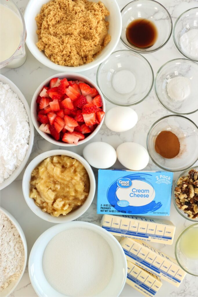 Overhead shot of individual strawberry banana cake ingredients on table