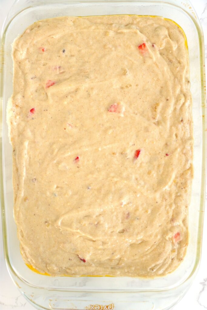 Overhead shot of strawberry banana cake batter in baking dish. 