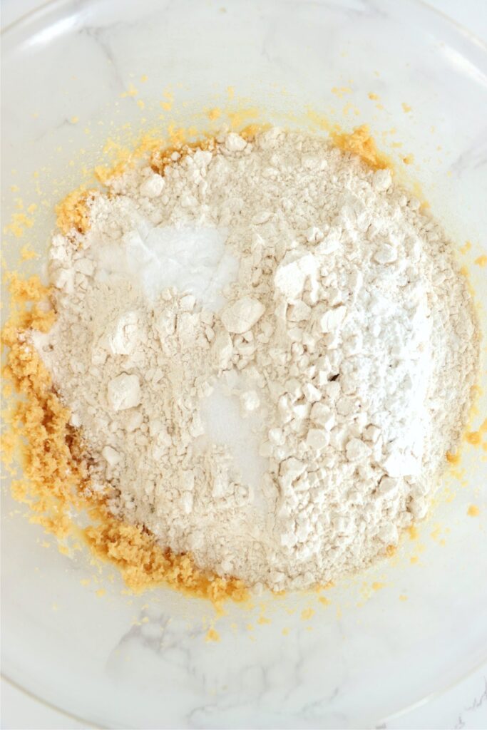 Overhead shot of dry ingredients on top of creamed butter and sugar.