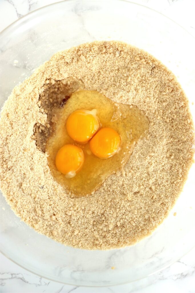 Overhead shot of eggs and vanilla in flour mixture. 