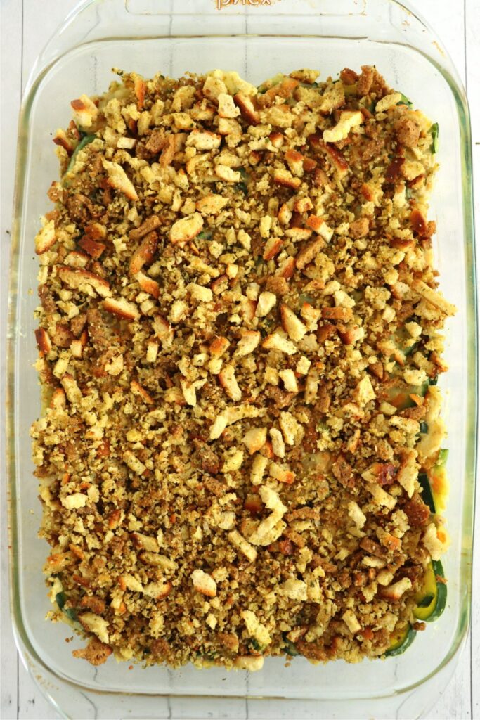 Overhead shot of old fashioned zucchini casserole topped with sutffing mix in baking dish.