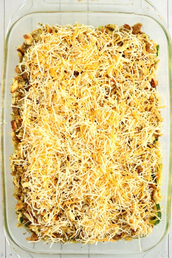 Overhead shot of old fashioned zucchini casserole topped with cheese in baking dish. 