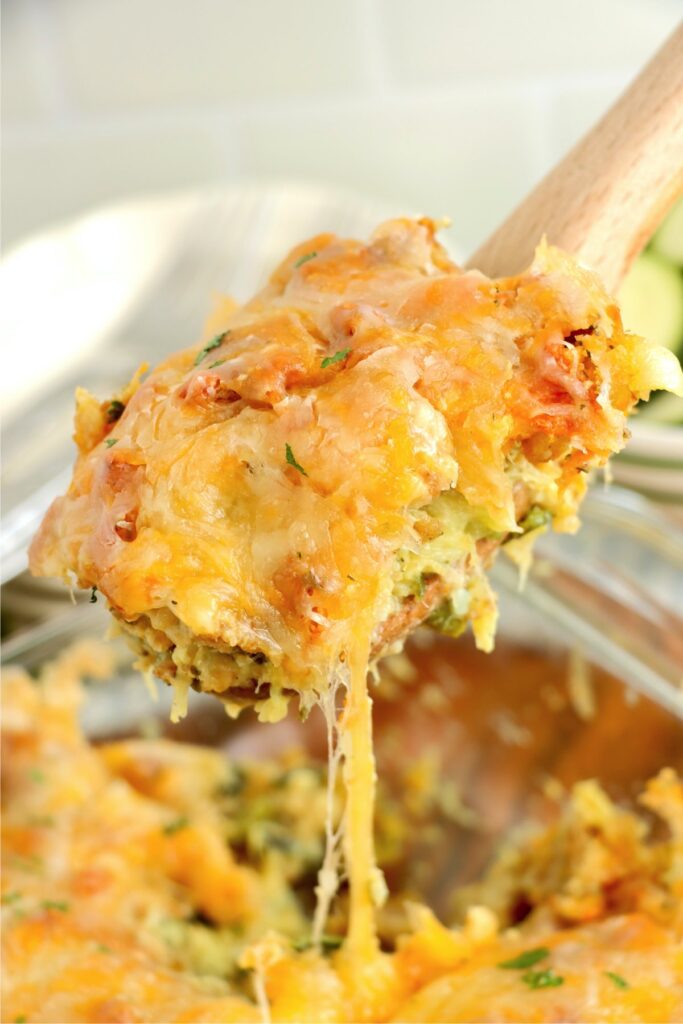 Closeup shot spoonful of cheesy old fashioned zucchini casserole 