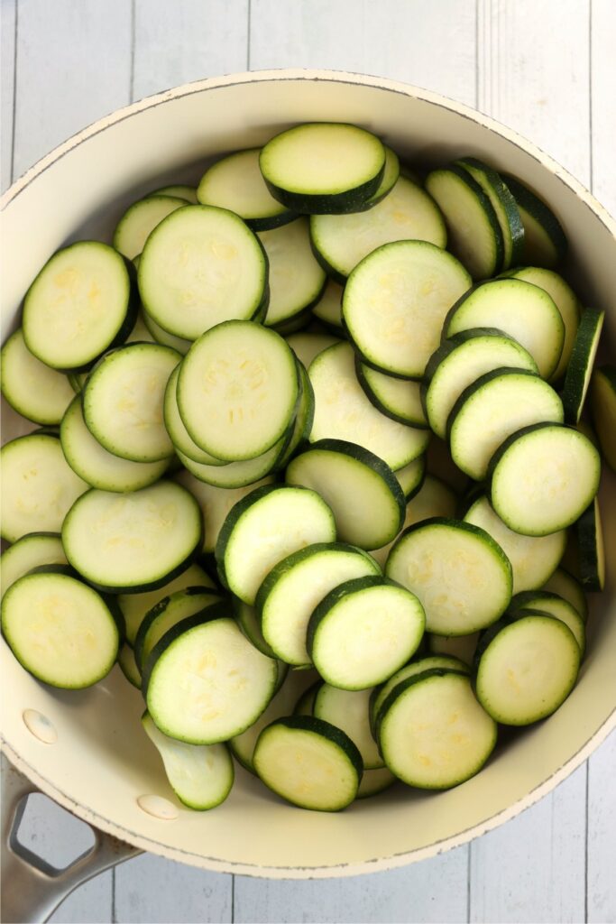 Overhead shot of sliced zucchini in pot. 