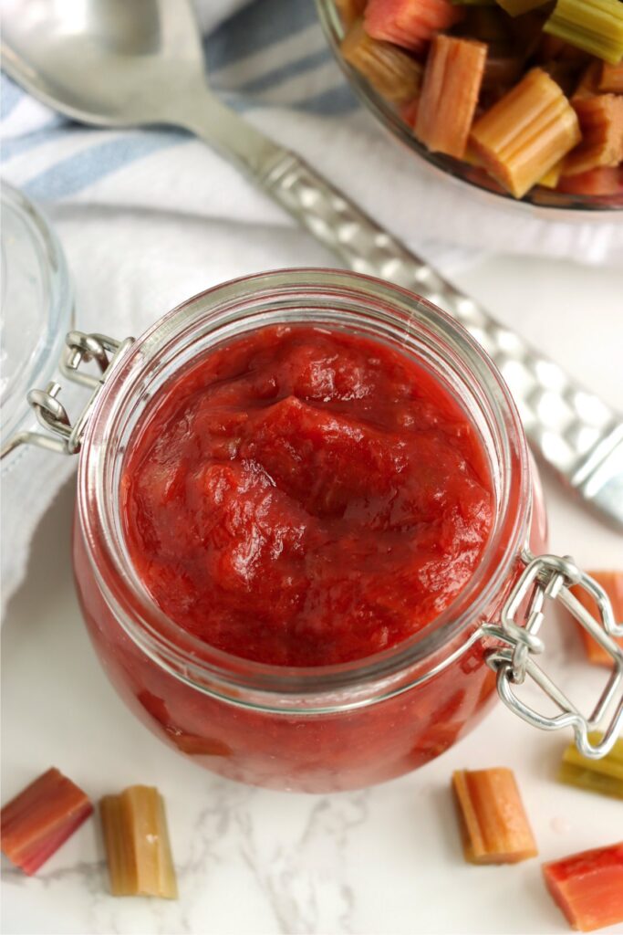 Closeup overhead shot of jarful of homemade rhubarb sauce. 