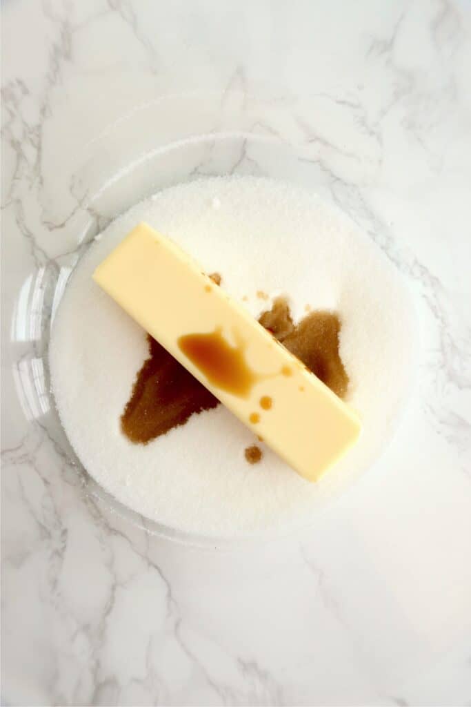 Closeup overhead shot of butter, sugar, and vanilla in bowl