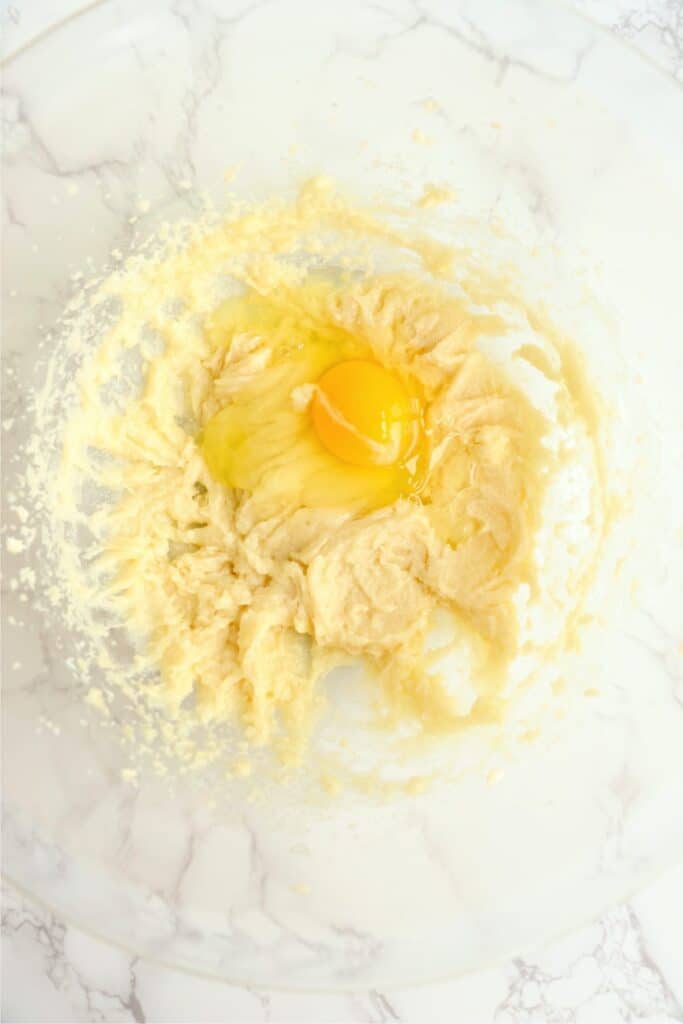 Overhead shot of creamed butter and sugar with eggs