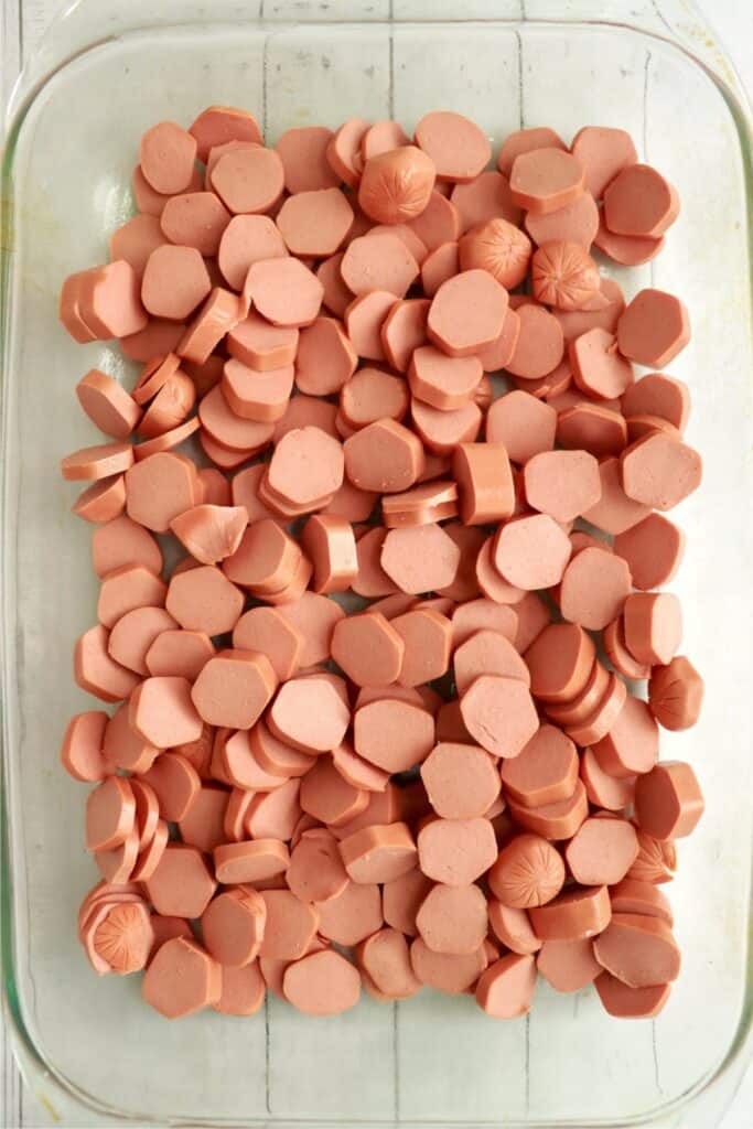 Overhead shot of sliced hot dogs in baking dish.