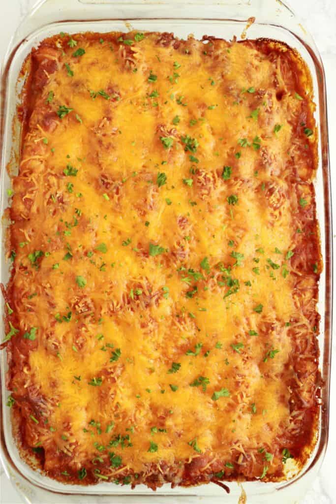 Overhead shot of chili cheese tater tot hot dog casserole in baking dish.