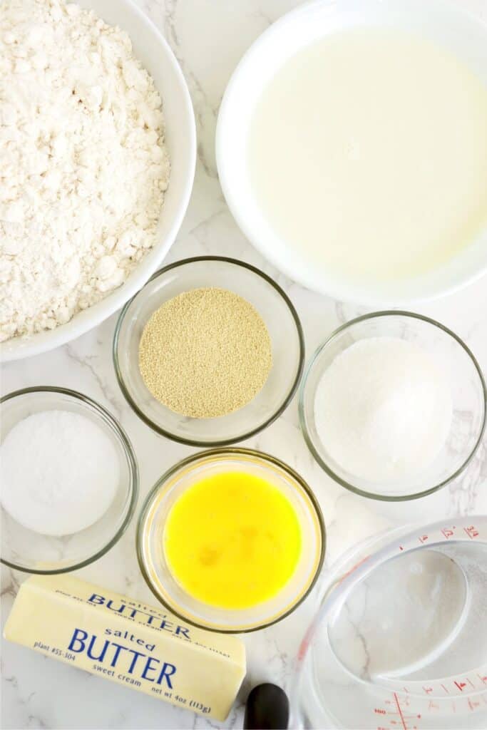 Overhead shot of individual country white bread ingredients in bowls on table