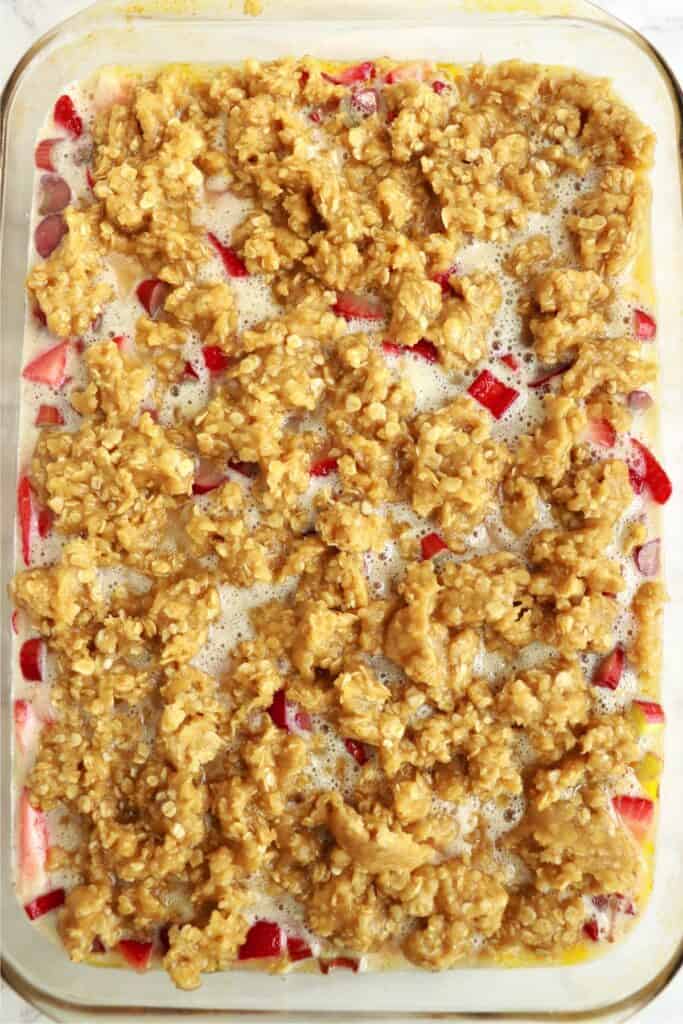 Overhead shot of unbaked rhubarb custard bars in baking dish