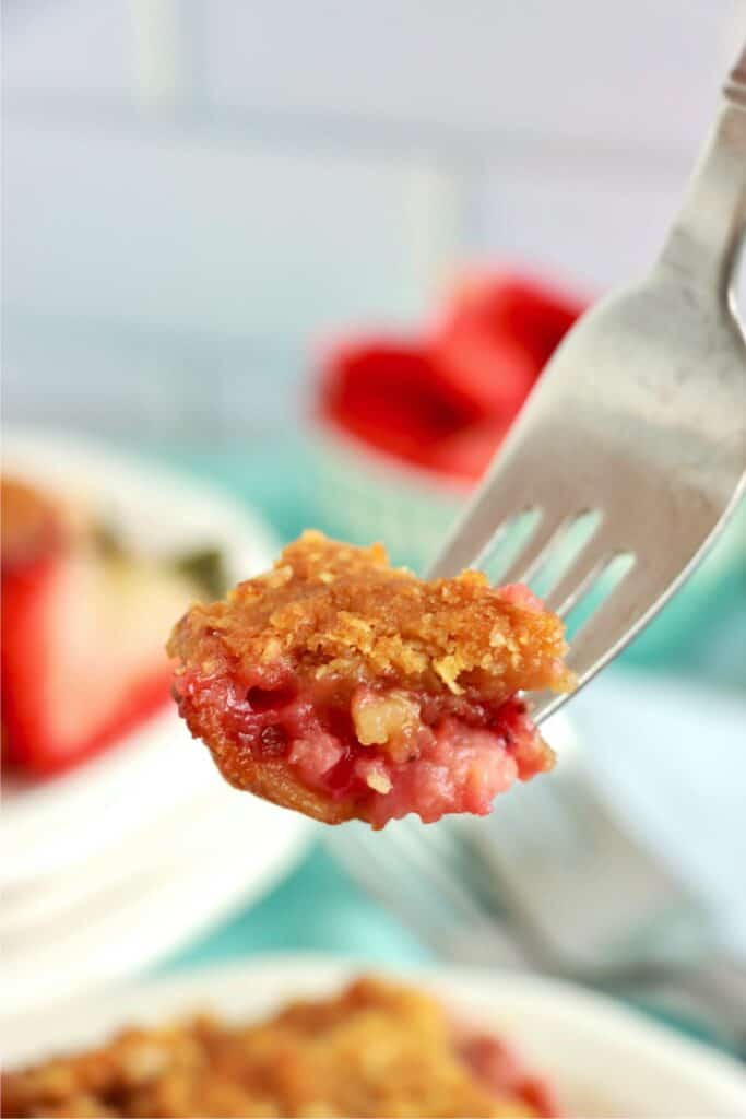 Closeup shot of forkful of rhubarb custard bar.