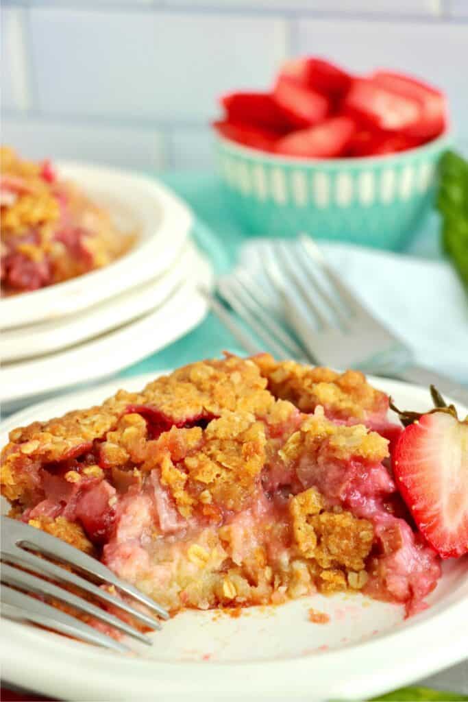 Closeup shot of rhubarb custard bar with bite taken out on plate