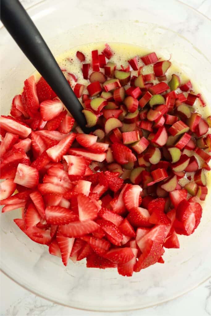 Overhead shot of strawberries and rhubarb in custard mixture