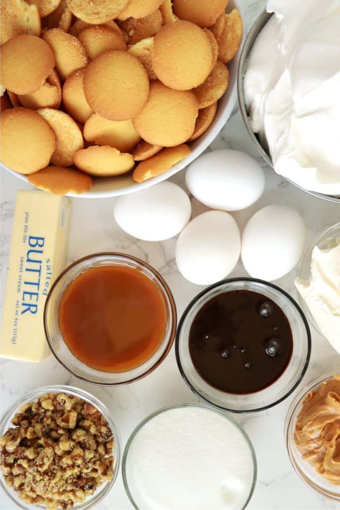 Overhead shot of drumstick ice cream cake ingredients in individual bowls on table