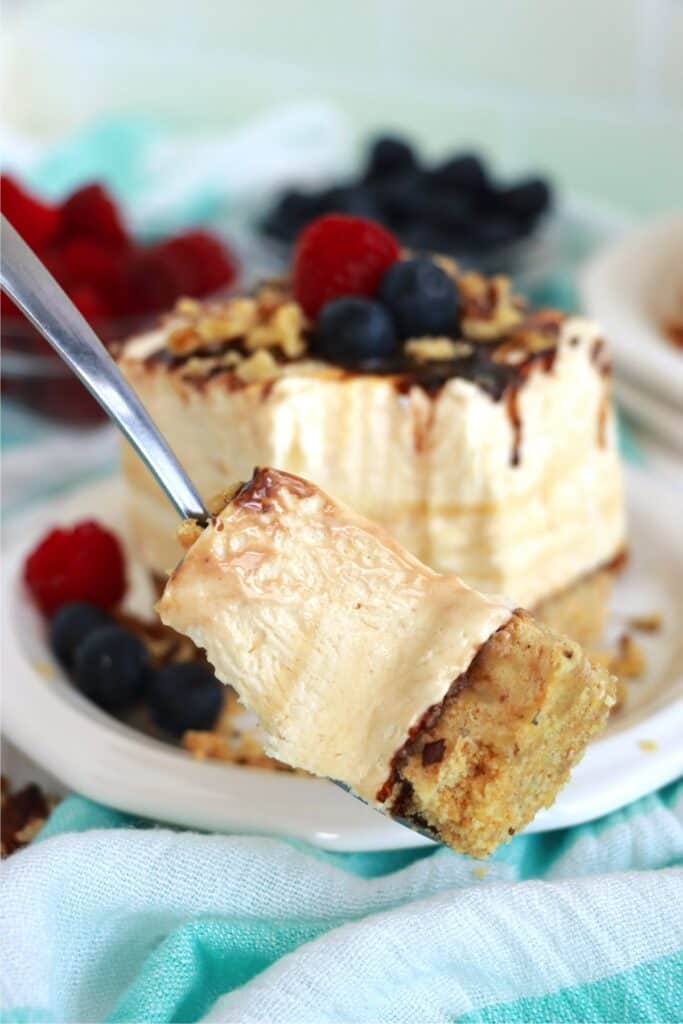 Closeup shot of forkful of drumstick ice cream cake with more in background on plate