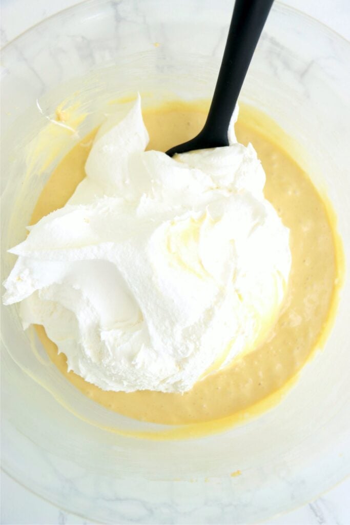 Whipped topping in bowl of cream cheese mixture
