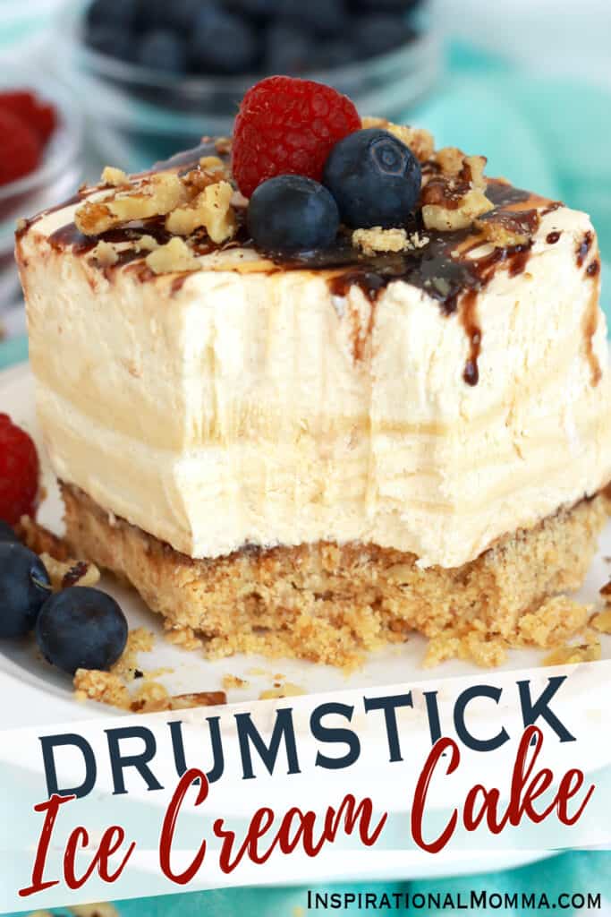 Closeup shot of slice of drumstick ice cream cake with bite taken out on plate. 