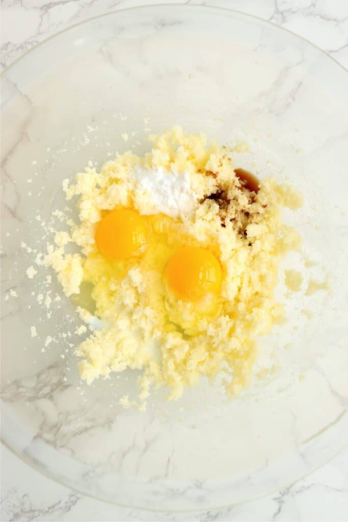 Overhead shot of creamed butter and sugar, eggs, bakin soad, milk, and vanilla.