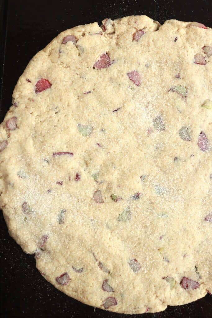 Overhead shot of homemade rhubarb scone dough sprinkled with sugar