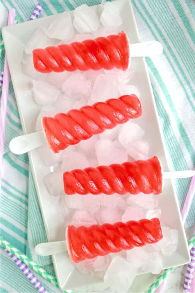 Overhead shot of Kool Aid popsicles on tray of ice.