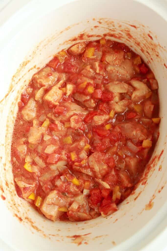 Overhead shot of uncooked chicken paprikash in slow cooker