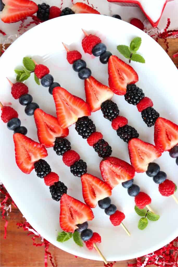 Overhead shot of 4th of July fruit kabobs on plate.