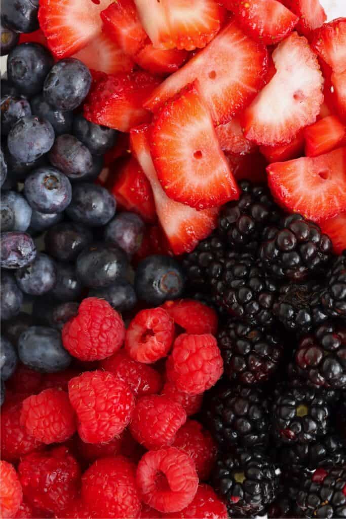 Closeup overhead shot of strawberries, raspberries, blackberrie, and blueberries. 