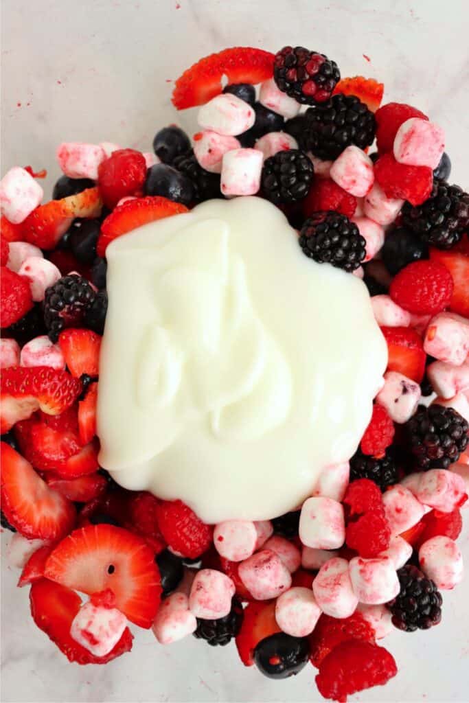 Closeup overhead shot of yogurt on top of mixed berries
