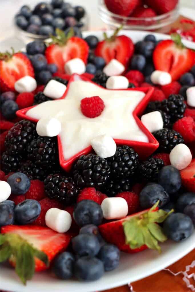Clioseup shot of platter filled with strawberries, blueberries, raspberries, and blackberries. 