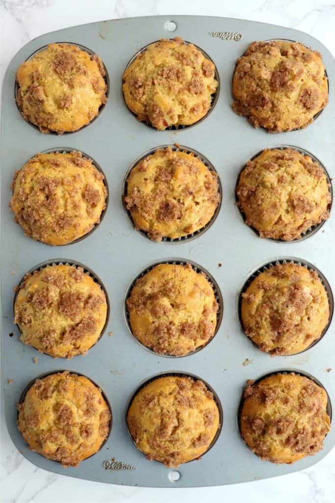 Overhead shot of baked homemade rhubarb muffins in muffin tin.