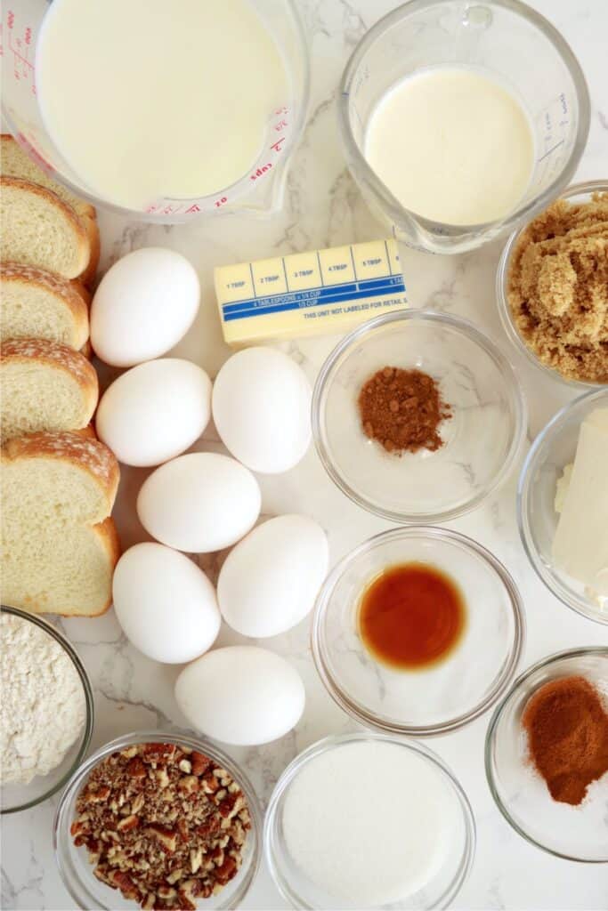 Overhead shot of cream cheese stuffed French toast ingredients in individual bowls on table