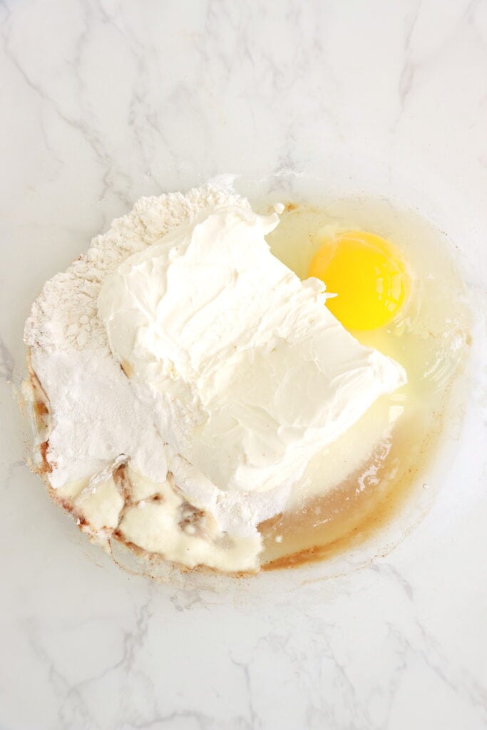 Overheat shot of all cream cheese filling ingredients in mixing bowl. 