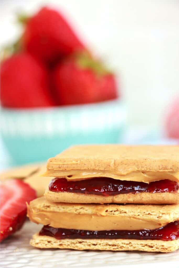 Closeup shot of two peanut butter and jelly graham crackers stacked atop one another