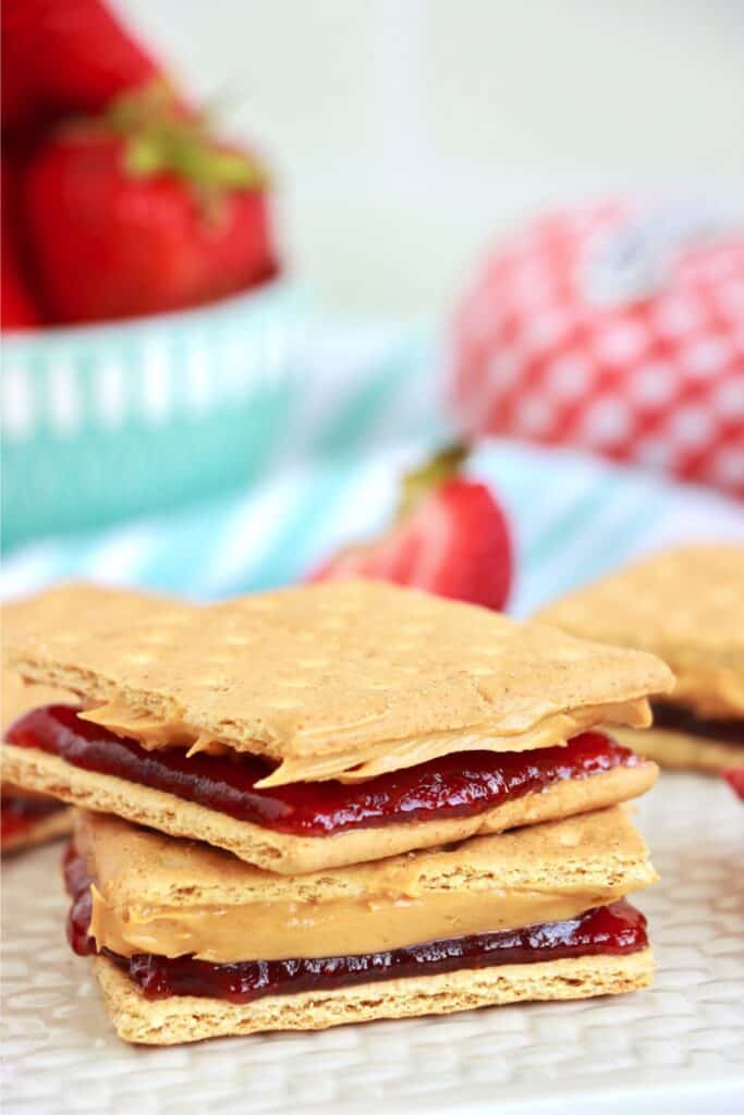 Two peanut butter and jelly graham crackers stacked atop one another. 