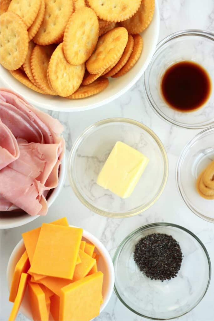 Overhead shot of ingredients for Ritz Cracker sandwiches in individual bowls on table. 