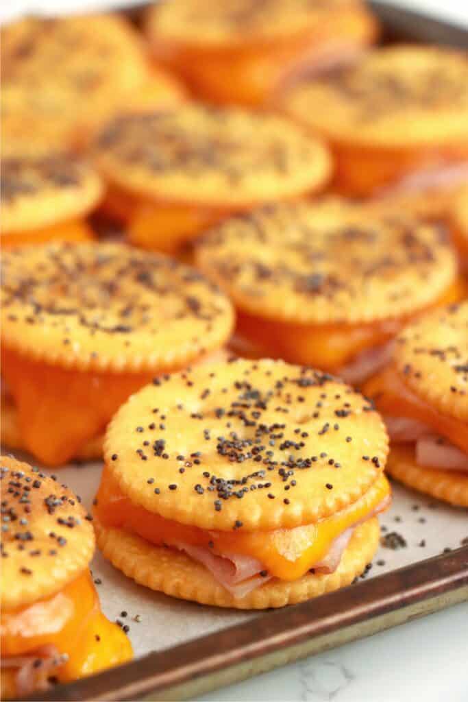 Closeup shot of baked Ritz cracker sandwiches on baking sheet. 