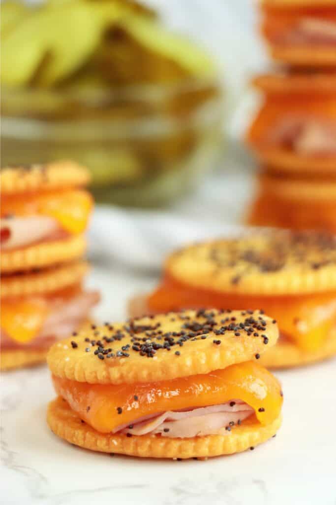 Closeup shot of Ritz cracker sandwiches with ham and cheese on table. 