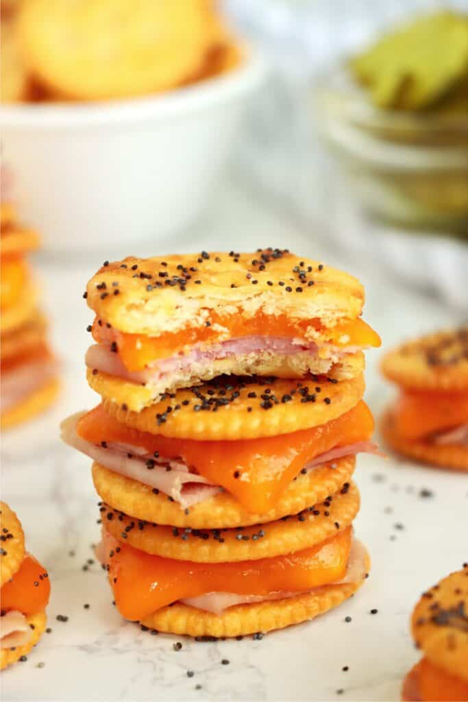 Closeup shot of Ritz cracker sandwiches stacked atop one another with bite taken out of top sandwich.