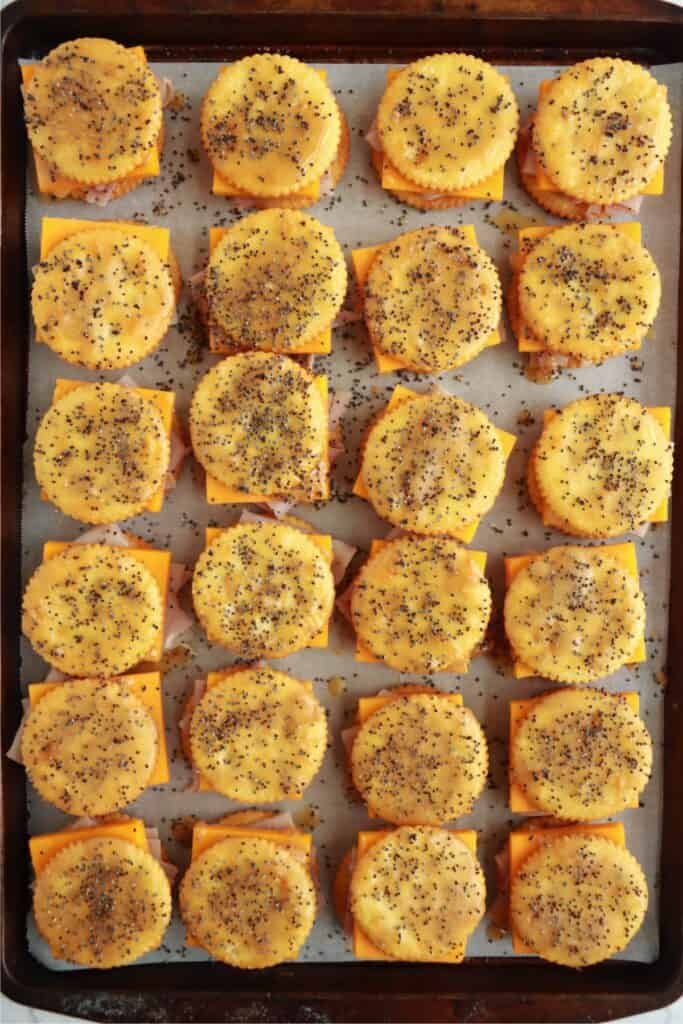 Overhead shot of Ritz cracker sandwiches topped with sesame seeds. 