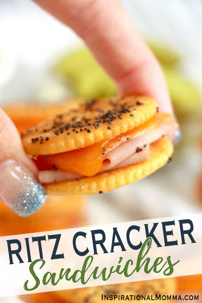 Closeup shot of hand holding a Ritz cracker sandwich.