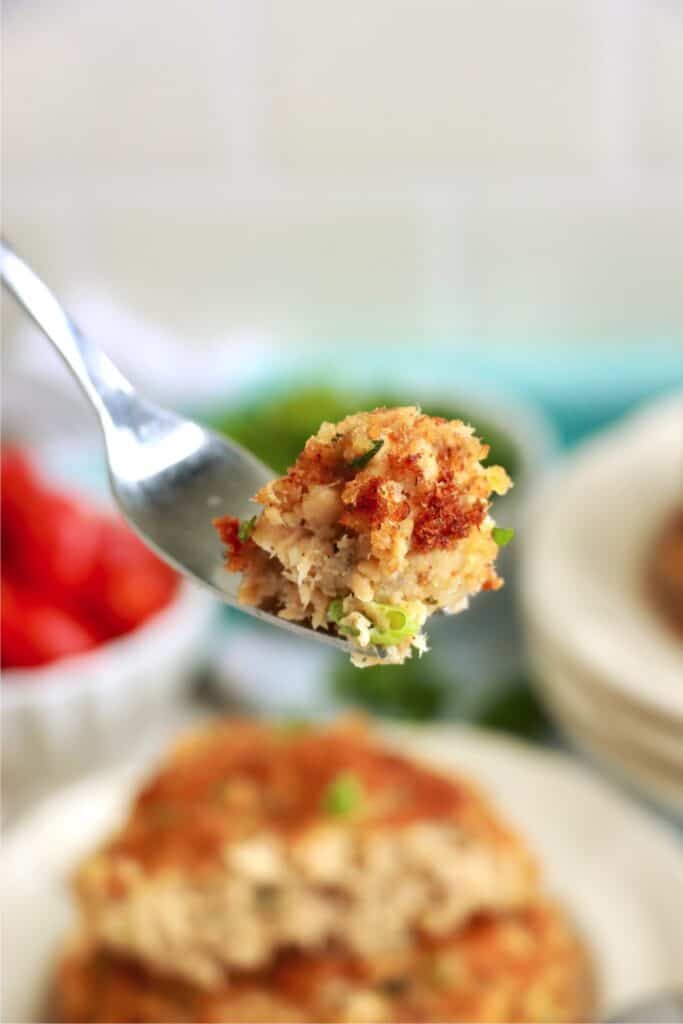 Closeup shot of forkful of salmon patty. 