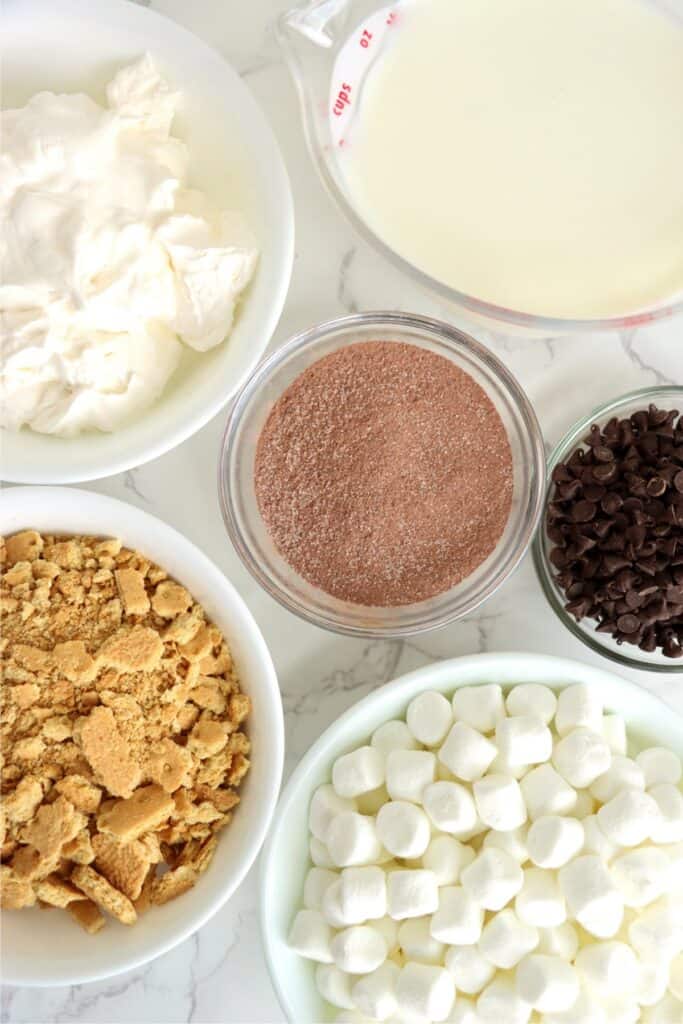 Overhead shot of individual S'Mores parfait recipe ingredients in bowls on table