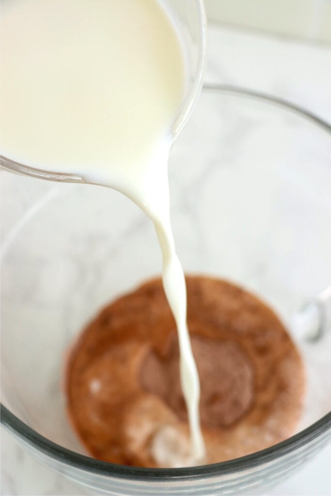 Milk being poured into bowl withi pudding mix