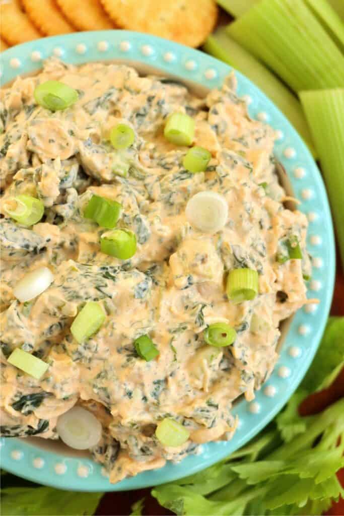 Overhead shot of Buffalo chicken spinach dip in bowl. 